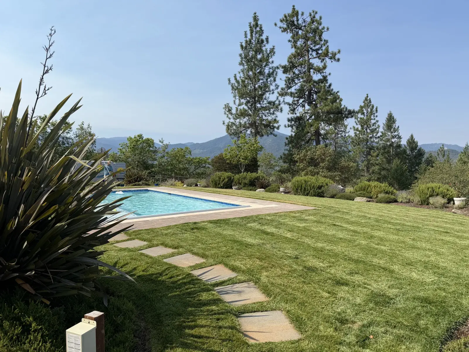 Lawn, stepping stone path and shrub beds maintained by Peak Landscaping on a Southern Oregon property